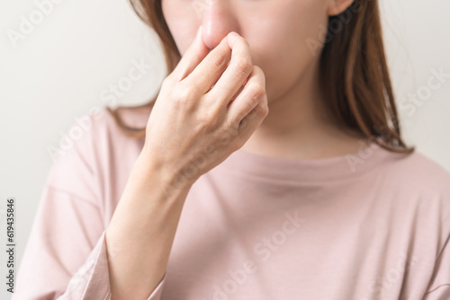 Bad smelling, deodorant asian young woman hand squeeze, covering nose smell stink, breathing smelly disgust strong, expression face dislike odor, smelly armpit underarm. Medical health, skin body care