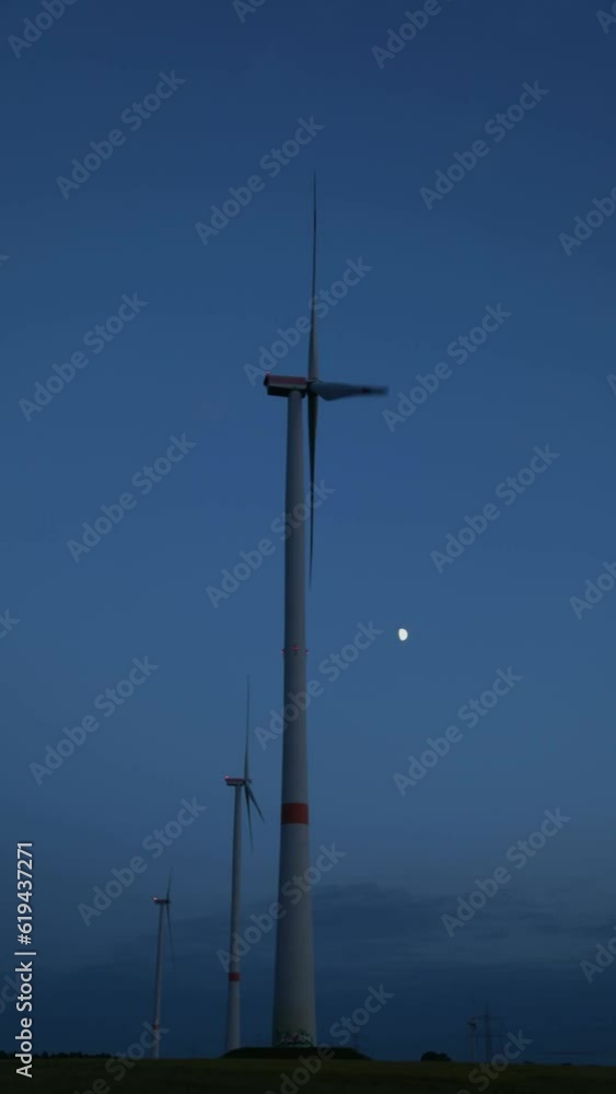 Wind turbines in front of evening sky, time lapse, moon, Melbeck, Ilmenau joint municipality, Lower Saxony, Germany, Europe
