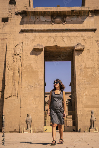 A young tourist at the entrance to the Edfu Temple near the Nile River in Aswan. Egypt, return of tourism in the coronavirus pandemic after 6 months stopped