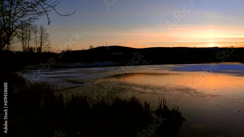 Sunset on the lake with ice