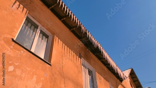 Spring drops from the roof in the bright sun