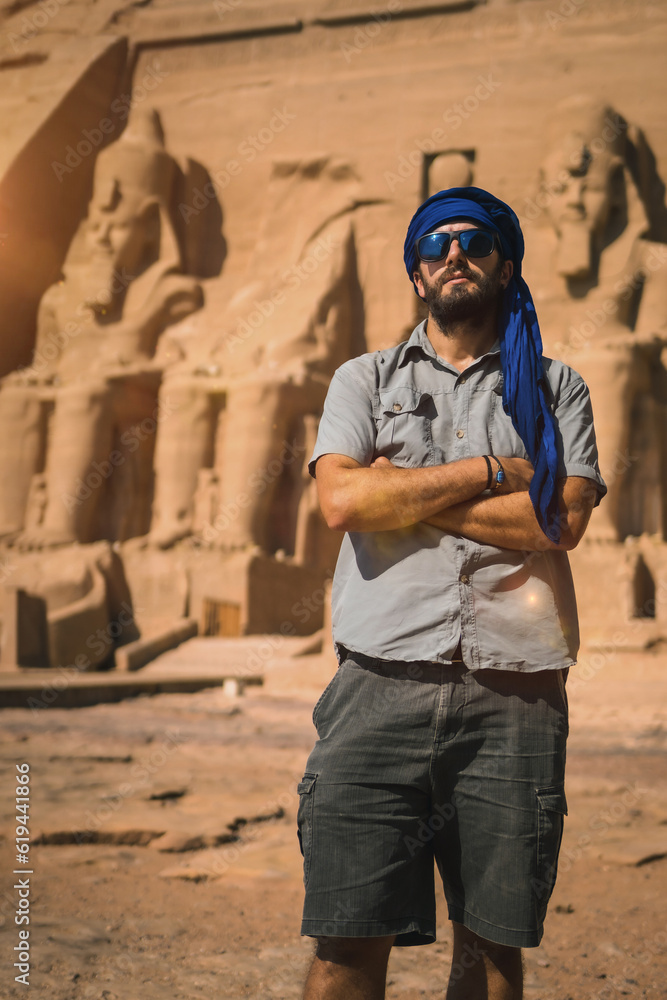 A young tourist with a blue turban visiting the Abu Simbel Temple in southern Egypt in Nubia next to Lake Nasser. Temple of Pharaoh Ramses II, travel lifestyle A young tourist with a blue turban visiting the Abu Simbel Temple in southern Egypt in Nubia next to Lake Nasser. Temple of Pharaoh Ramses II, travel lifestyle