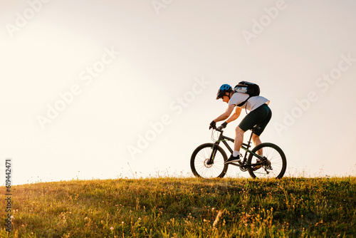 Professional mountain bike cyclist riding on white background active lifestyle. © Malik Nalik
