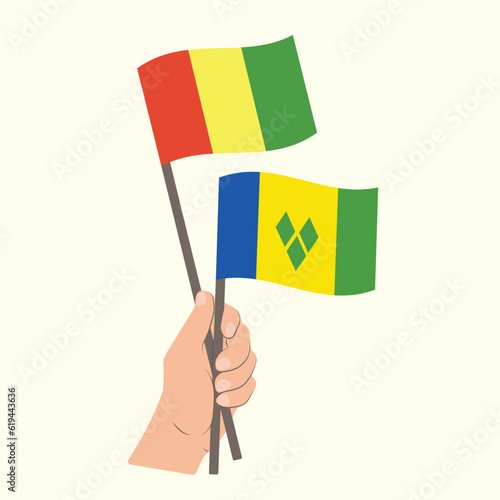 Flags of Guinea and Saint Vincent and the Grenadines  Hand Holding flags