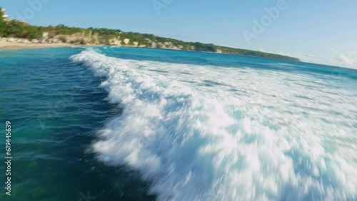 fpv drone flight over dreamland beach with whaiter sand in bali