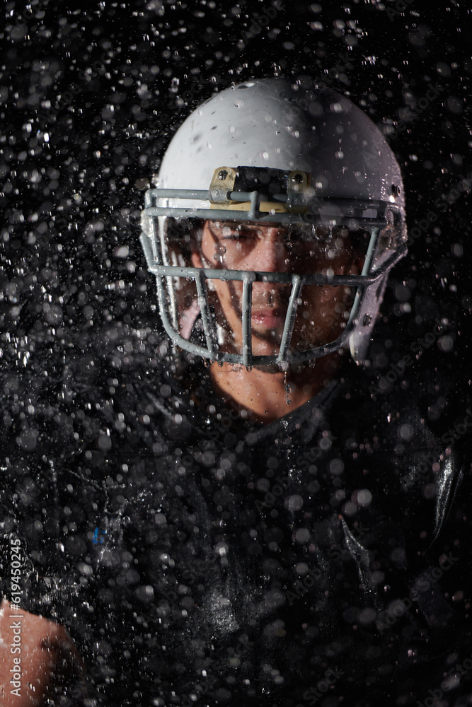 American Football Field: Lonely Athlete Warrior Standing on a Field Holds his Helmet and Ready to Play. Player Preparing to Run, Attack and Score Touchdown. Rainy Night with Dramatic Fog, Blue Light American Football Field: Lonely Athlete Warrior Standing on a Field Holds his Helmet and Ready to Play. Player Preparing to Run, Attack and Score Touchdown. Rainy Night with Dramatic Fog, Blue Light