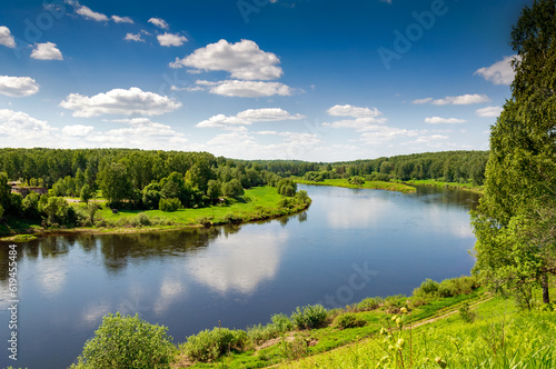 Beautiful summer landscape of meadows near the river and forest. The upper reaches of the Volga River in the Tver region of Russia.