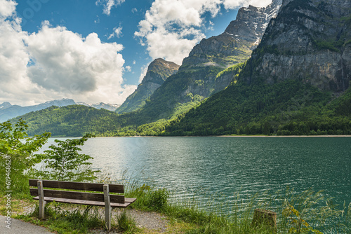 Bench on the shore with idyllic view of Lake Kloentalersee, Kloental, Glarner Alp,, Canton Glarus, Switzerland photo