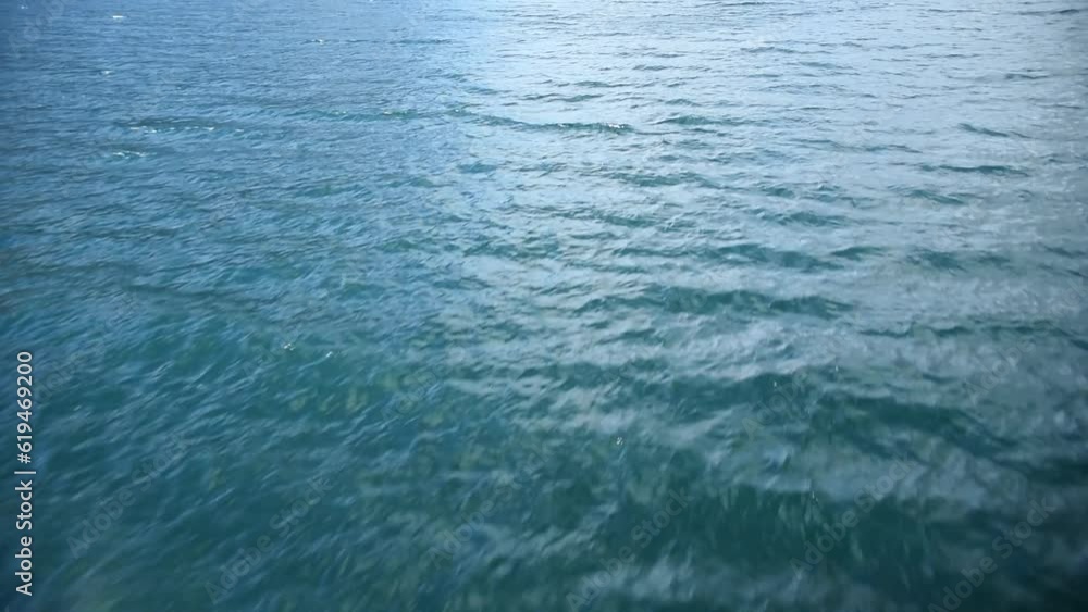 low flight over a clear blue water surface, background Blue water waves surface, beautiful background with copy space. Fresh drinking water, low flight over a clear blue water surface, background Blue water waves surface, beautiful background with copy space. Fresh drinking water,