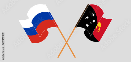 Crossed and waving flags of Russia and Papua New Guinea
