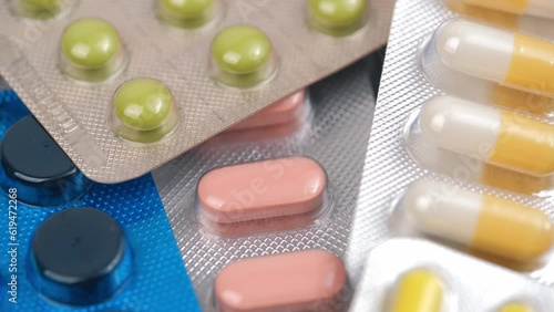 closeup with rotating pills and medicines with blister packaging. concept of medicine, pharmacy, healthcare, pharmaceutical industry. top view.