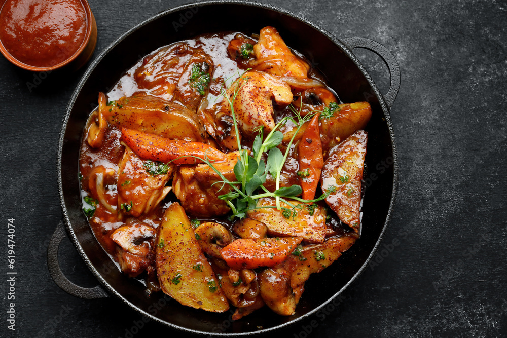 Fototapeta premium Stewed potatoes with sauce, mushrooms and vegetables
