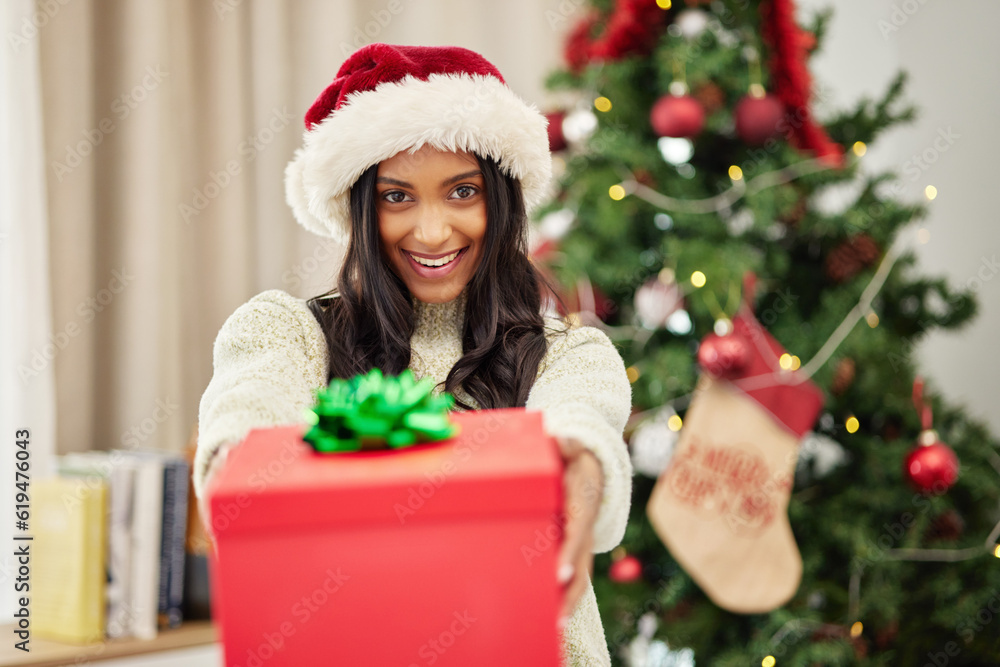 Woman giving gift, Christmas and smile in portrait, celebrate holiday with happiness and wrapped box with ribbon. Special event, female person at home with present and package, festive and xmas Woman giving gift, Christmas and smile in portrait, celebrate holiday with happiness and wrapped box with ribbon. Special event, female person at home with present and package, festive and xmas