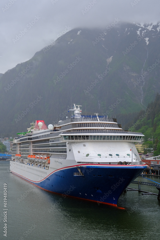 Modern cruiseship cruise ship liner Spirit docked at terminal in Juneau, Alaska during heavy rain and low cloud nature scenery with mountains and foggy misty atmosphere Modern cruiseship cruise ship liner Spirit docked at terminal in Juneau, Alaska during heavy rain and low cloud nature scenery with mountains and foggy misty atmosphere