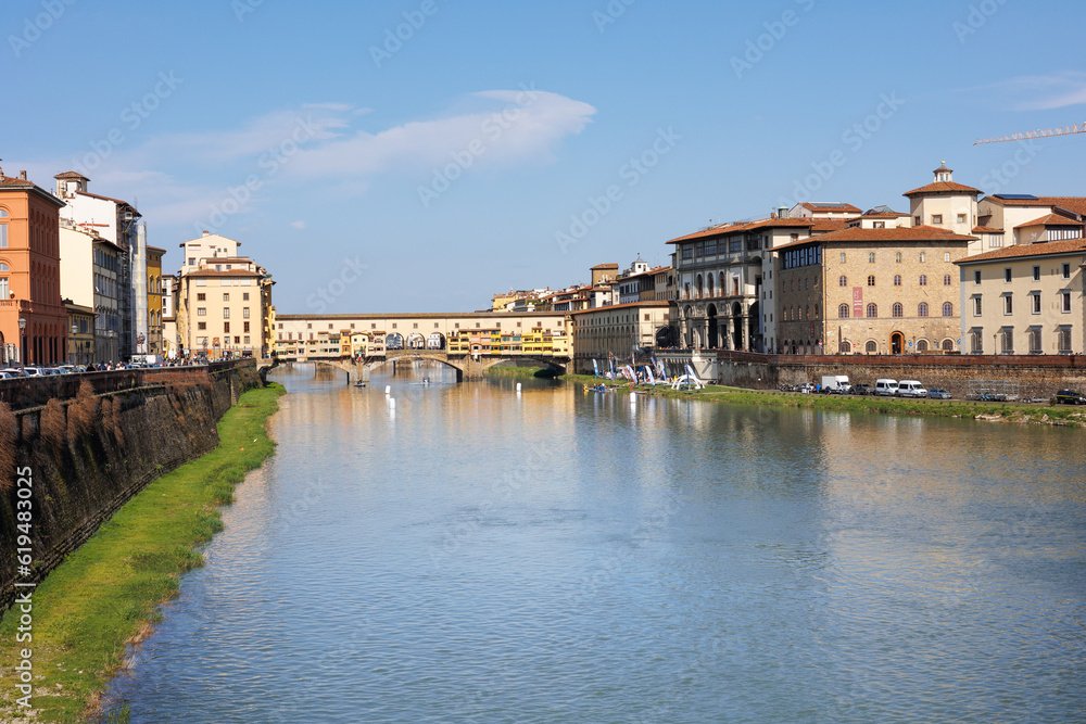 Fototapeta premium Arno River and Ponte Vecchio in the Background on a Beautiful Sunny Spring Day in Florence, Italy