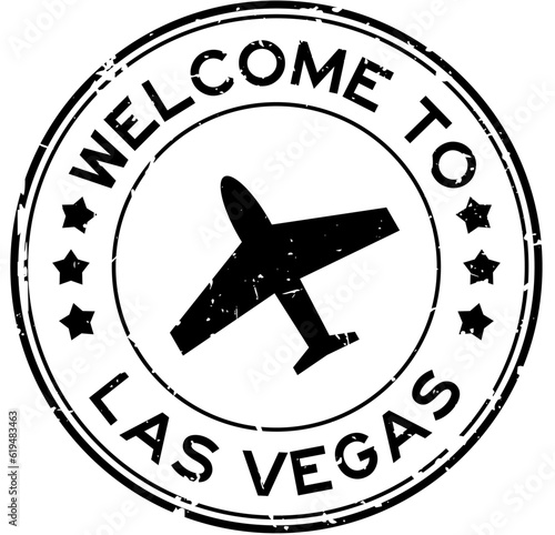 Grunge black welcome to las vegas with airplane icon round rubber seal stamp on white background