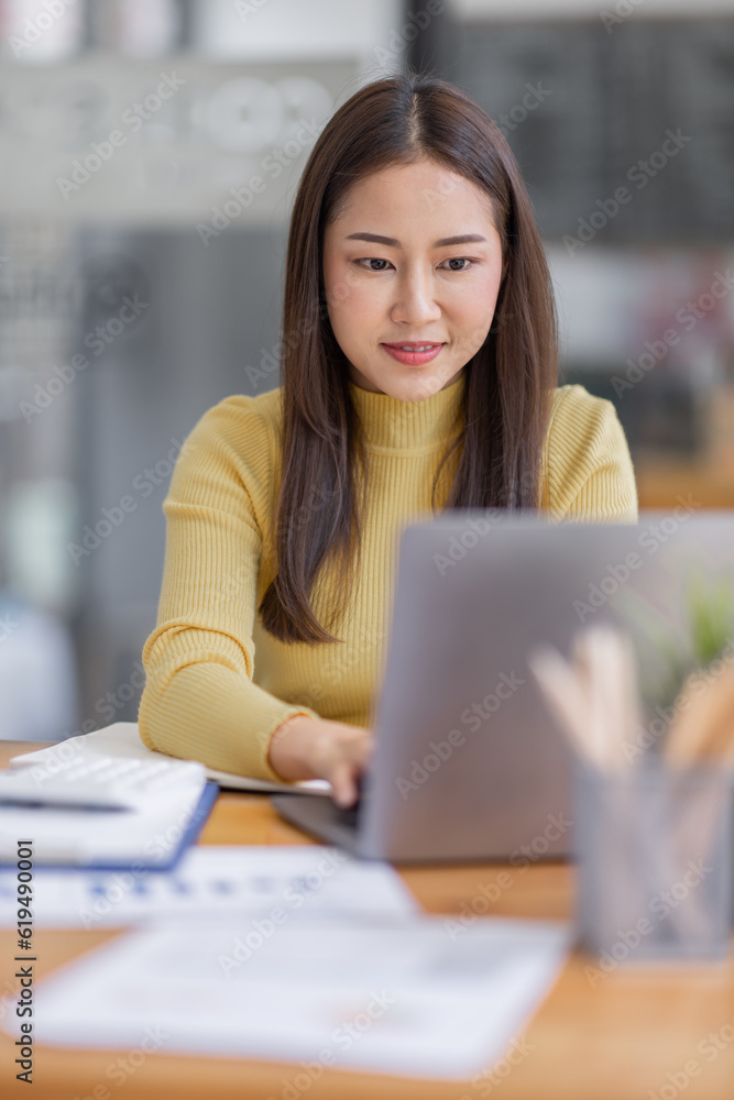 Business asian women working on laptop in office, calculating income-expenditure and analyzing real estate investment data, Accounting Financial and tax systems concept. Business asian women working on laptop in office, calculating income-expenditure and analyzing real estate investment data, Accounting Financial and tax systems concept.