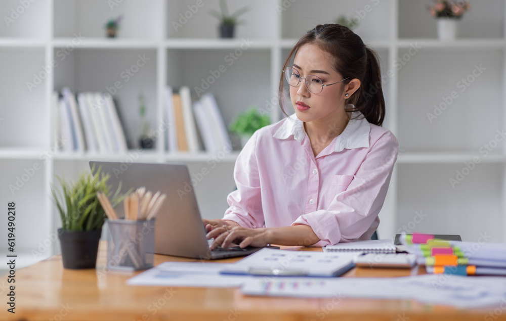 Business asian women working on laptop in office, calculating income-expenditure and analyzing real estate investment data, Accounting Financial and tax systems concept. Business asian women working on laptop in office, calculating income-expenditure and analyzing real estate investment data, Accounting Financial and tax systems concept.