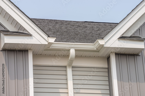 Fototapeta gutter with downpipe on the roof of a house metal pipe