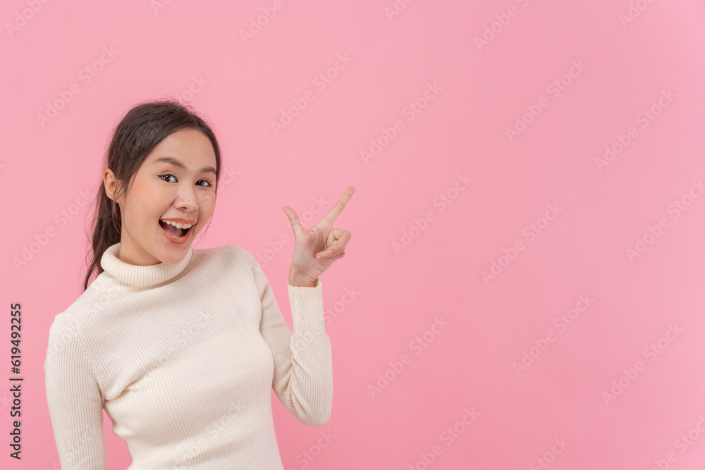 Portrait beautiful girl pointing blank space isolated background. Happy woman pointing on something. young female standing pointing finger sideways, billboard, introduction, advertisement Portrait beautiful girl pointing blank space isolated background. Happy woman pointing on something. young female standing pointing finger sideways, billboard, introduction, advertisement