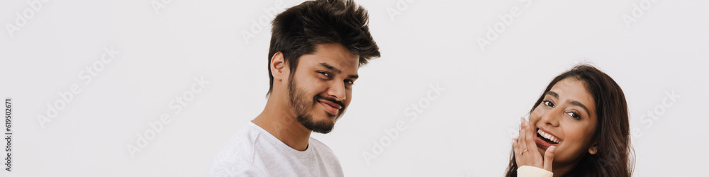 Fototapeta premium Young indian couple laughing while posing with credit card