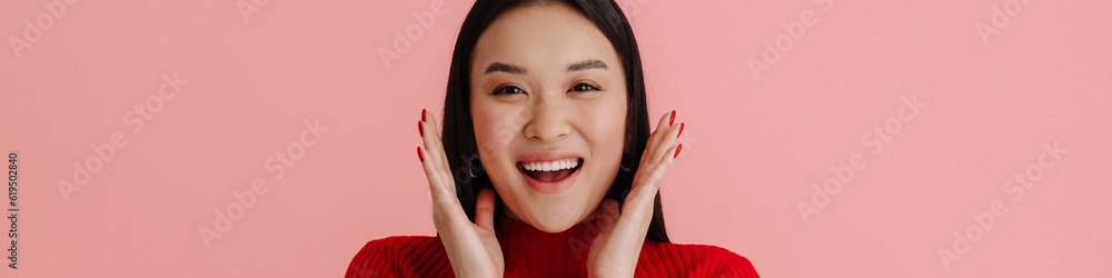 Asian young woman wearing earrings smiling and looking at camera Asian young woman wearing earrings smiling and looking at camera