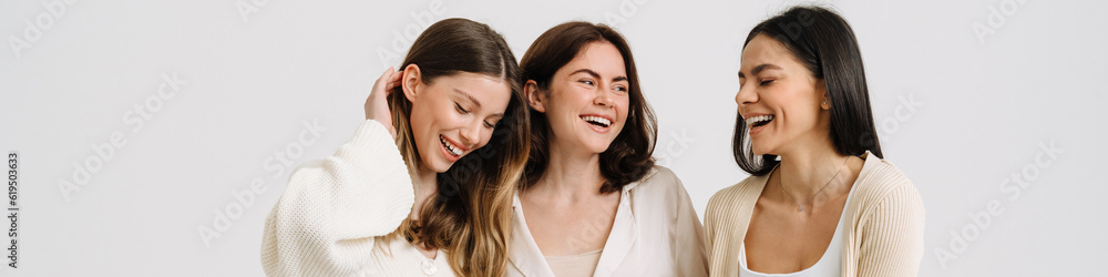 Three gorgeous brunette women posing at camera together Three gorgeous brunette women posing at camera together