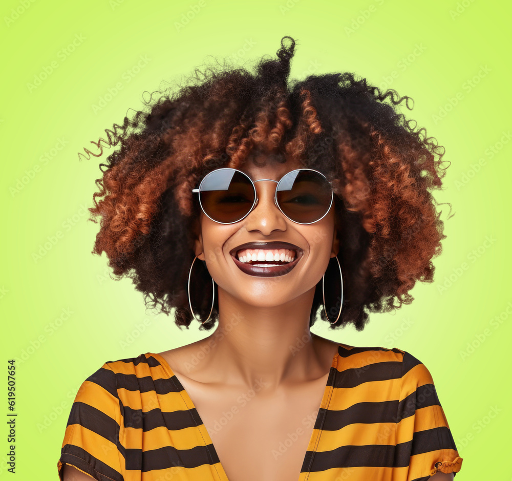 An African American woman with an afro hairstyle smiling and wearing sunglasses An African American woman with an afro hairstyle smiling and wearing sunglasses