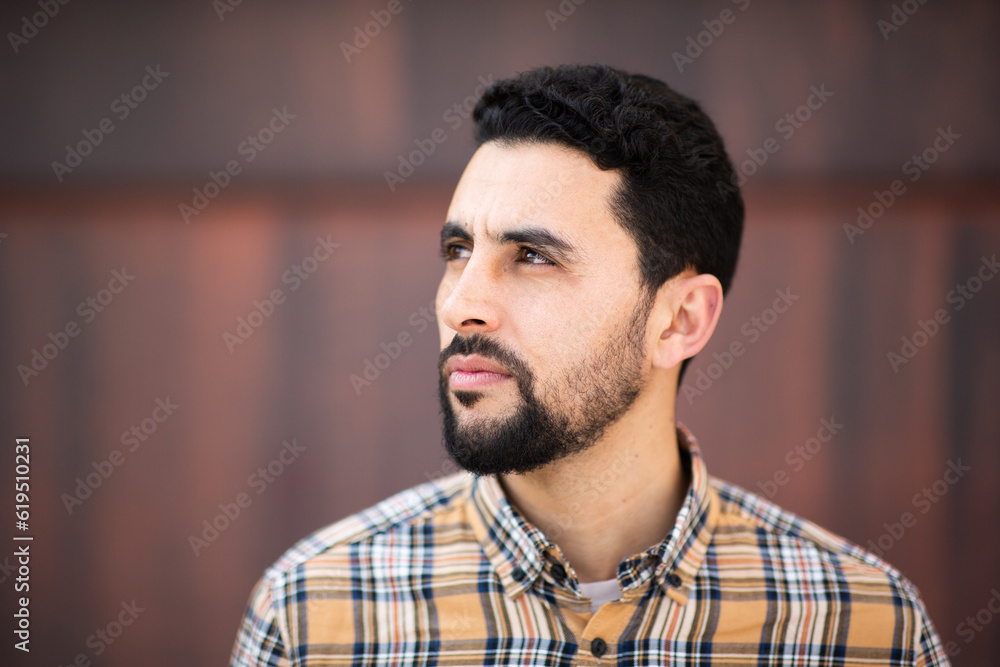 Fototapeta premium Young North African man looking away with serious expression