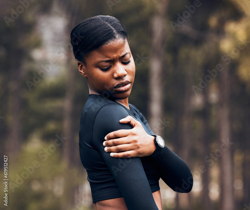 Shoulder, pain and sports woman outdoor for health risk, bruise and hands on wound in park. Fitness, black female athlete and arm injury of muscle, joint problem and first aid for exercise accident