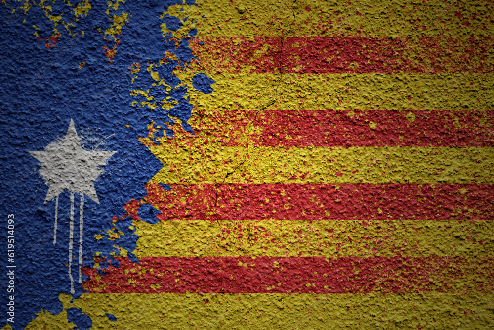 painted big national flag of catalonia on a massive old cracked wall - obrazy, fototapety, plakaty 