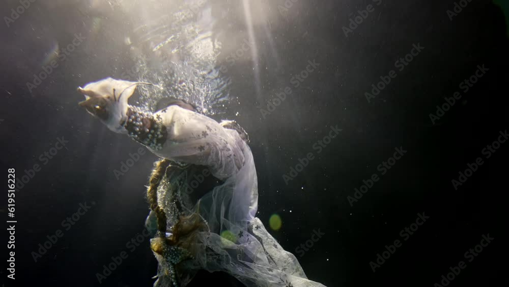 enigmatic queen in gorgeous gown and pearl crown floating underwater, fairytale and fantasy enigmatic queen in gorgeous gown and pearl crown floating underwater, fairytale and fantasy