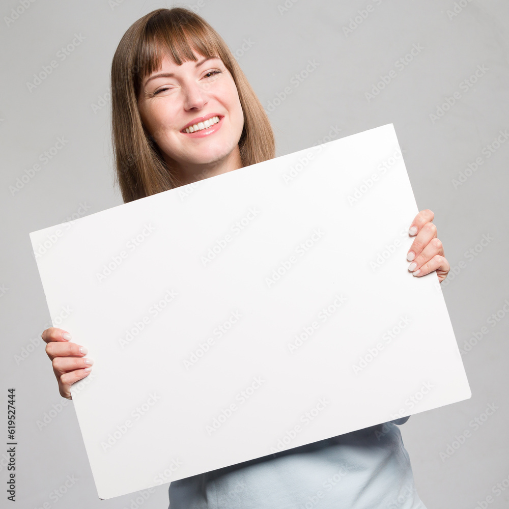 Young happy woman with an empty advertising board ready for lettering in her hands Young happy woman with an empty advertising board ready for lettering in her hands