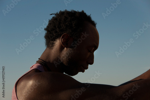 Photographs of a young black gay man practicing Reiki in the desert. 