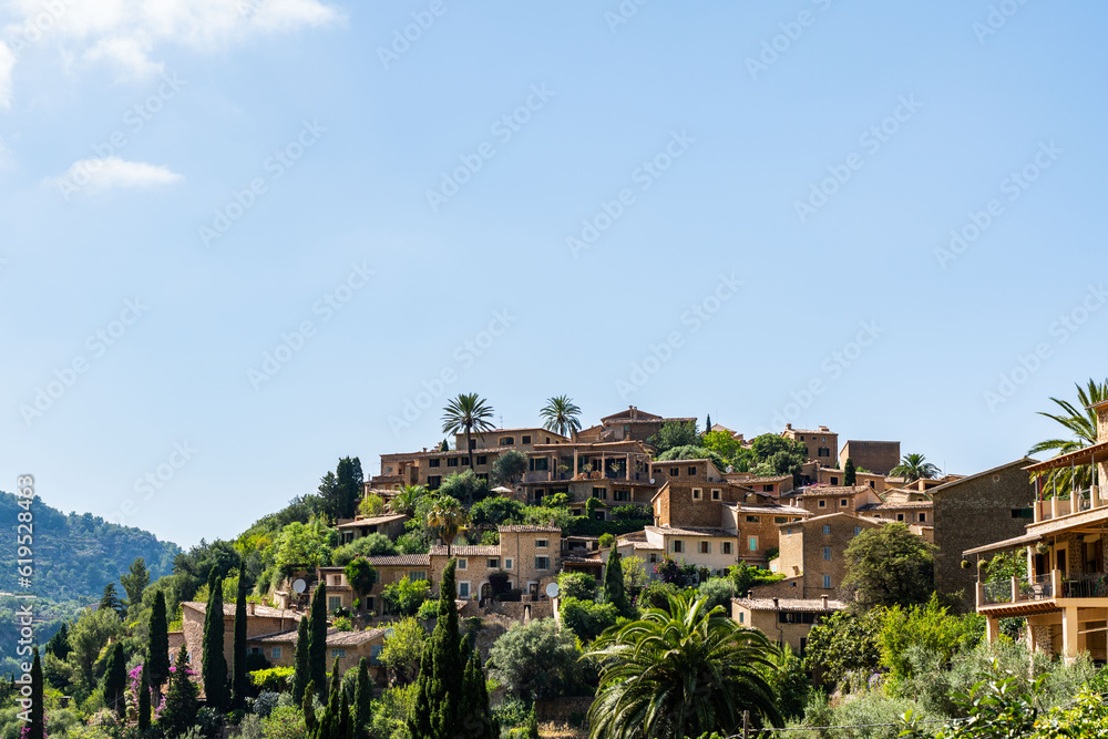 Village Deia in Mallorca, Spain. Houses in terraces surrounded by green trees