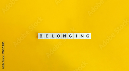 Belonging Word on Block Letter Tiles on Yellow Background. Minimal Aesthetic.