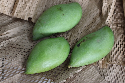 Totapuri raw mangoes or Magnifera indica. It is an oblong shaped mango with prominent beak photo