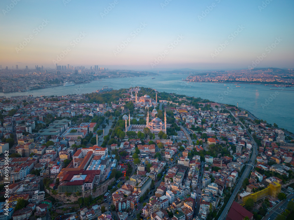 Blue Mosque Sultan and Hagia Sophia aerial view at sunset with Bosphorus Strait in Sultanahmet in city of Istanbul, Turkey. Historic Areas of Istanbul is a UNESCO World Heritage Site since 1985. 