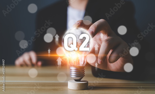 Business Profit growth, Financial report, Second quarter Concept. 2nd quarter positive growth performance report light bulb idea, increasing financial, Q2, stock, analysis, Business chart, success. photo