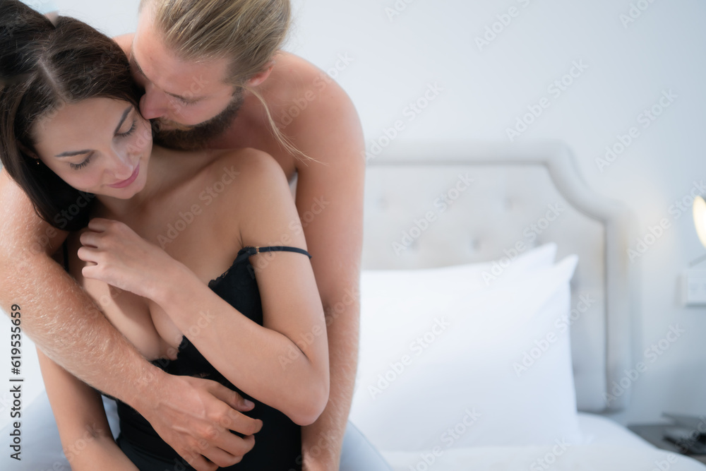Young man and beautiful young women in sexy black lingerie on the bed. Young man and beautiful young women in sexy black lingerie on the bed.