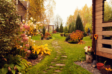 beautiful autumn garden view with curvy lawn pathway. Private natural country garden in october