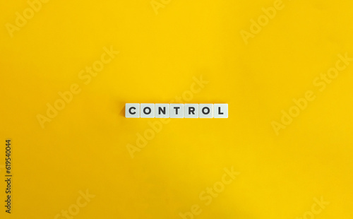 Control Word on Block Letter Tiles on Yellow Background. Minimal Aesthetic.