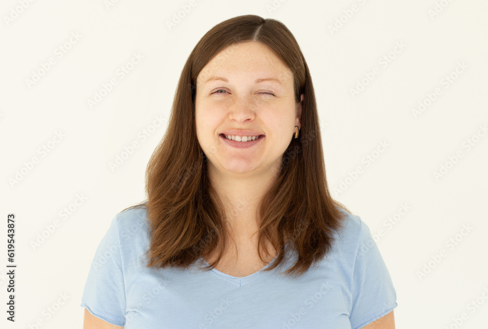 Portrait of funky young person isolated on white background wink eye and toothy smile Portrait of funky young person isolated on white background wink eye and toothy smile