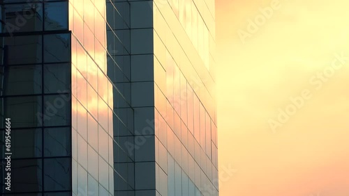 Office builiding, exterior view on the sky background with colorful yellow and orange clouds, public urban scene, panning, close up, time lapse, long exposure, multiple exposure, perspective. ProResHQ