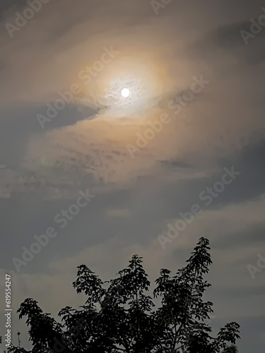 amazing cloudy sky and the moon behind it , July,3,2023 : Rampur Uttar Pradesh India.