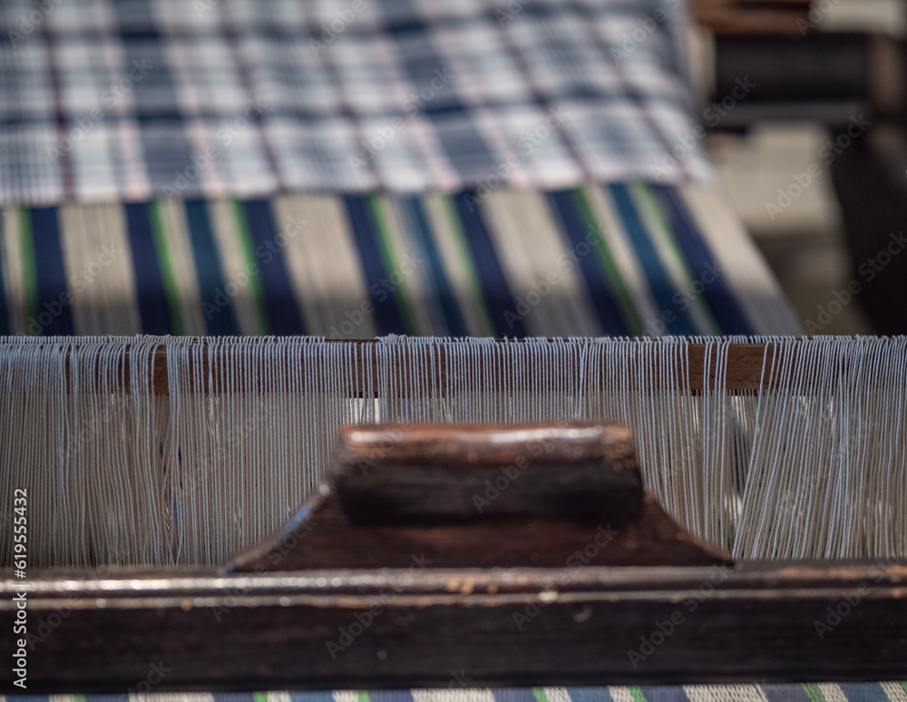 old and vintage loom with woven cloth