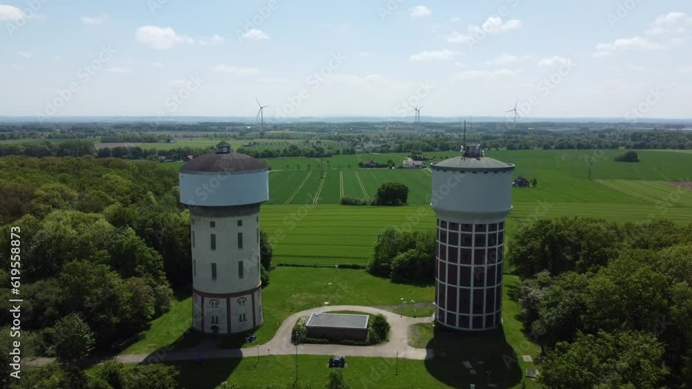 A smooth span overlooking two water towers, against a backdrop of green, cultivated fields, and trees. Water towers in Hamm, Germany. A smooth span overlooking two water towers, against a backdrop of green, cultivated fields, and trees. Water towers in Hamm, Germany.
