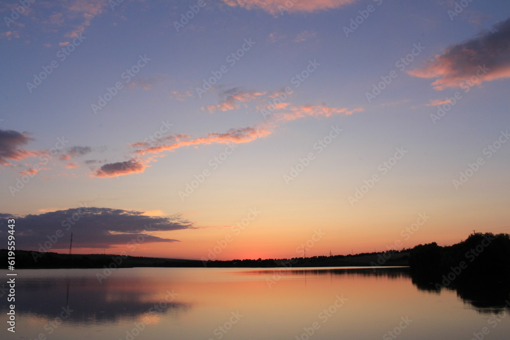 A body of water with a sunset in the background A body of water with a sunset in the background
