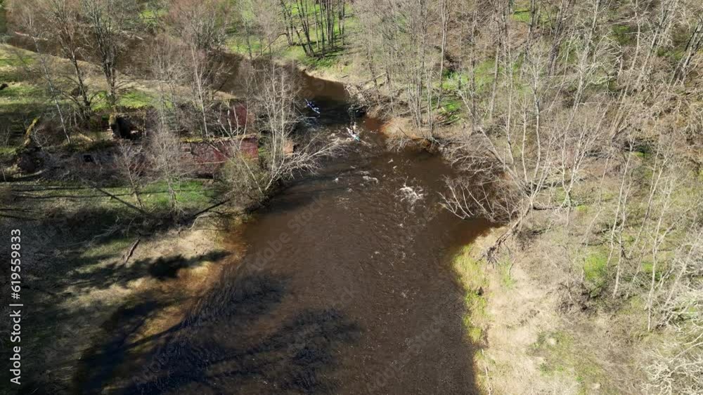 Drone shot on a sports canoe driven by a team of men and women sailing along a river. Outdoor activities on a kayak, water sports. Go Everywhere. Family Sports. Summer. Sport canoe operated by team Drone shot on a sports canoe driven by a team of men and women sailing along a river. Outdoor activities on a kayak, water sports. Go Everywhere. Family Sports. Summer. Sport canoe operated by team
