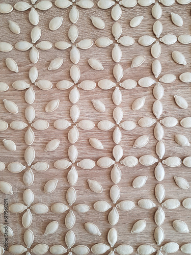 Pattern pumpkin seed ornament on a wooden background
